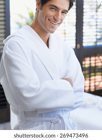smiling young man in luxurious bathrobe