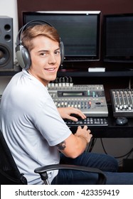 Smiling Young Man Mixing Audio In Recording Studio