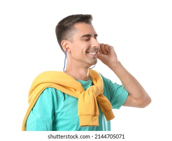 Smiling Young Man Putting Earplugs On White Background