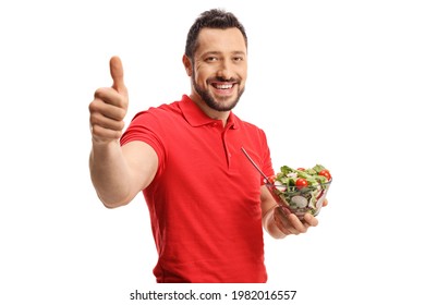 Smiling Young Man In A Red T-shirt Eating A Healthy Fresh Salad And Showing Thumbs Up Isolated On White Background