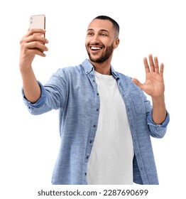 Smiling young man taking selfie with smartphone on white background - Powered by Shutterstock