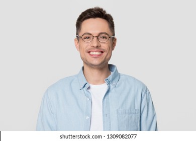 Smiling young man wearing shirt and glasses looking at camera, millennial guy nerd isolated on white grey studio blank background, funny male student geek in spectacles with happy face portrait - Shutterstock ID 1309082077