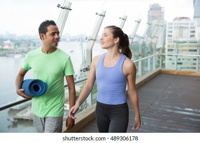 Smiling young man and woman walking after sports - Powered by Shutterstock