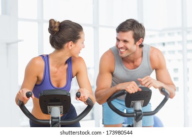 Smiling Young Man And Woman Working Out At Class In Gym