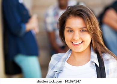 smiling young middle school girl with friends on background