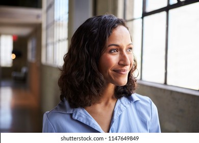 Smiling young mixed race businesswoman looking away - Powered by Shutterstock