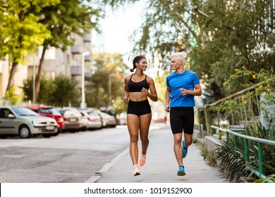 Smiling Young Mixed Race Couple Exercising Outside