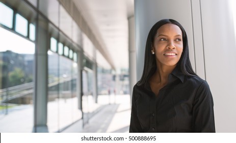 Smiling young mixed race latina businesswoman portrait outdoors in Milan with modern building as background. - Shutterstock ID 500888695