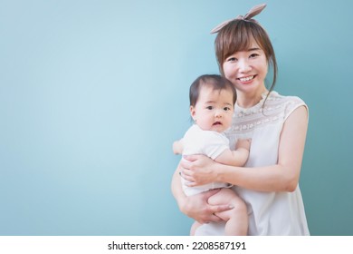 Smiling Young Mom Holding A Baby