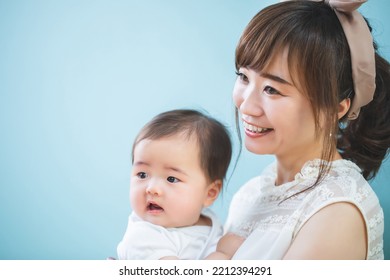 Smiling Young Mom Holding A Baby