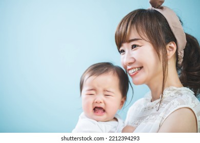 Smiling Young Mom Holding A Baby