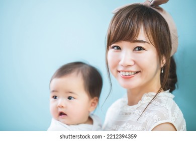 Smiling Young Mom Holding A Baby