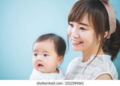 Smiling Young Mom Holding A Baby