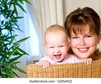 Smiling Young Mum And Baby In A Home Interior