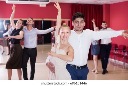 Smiling Young People Dancing Samba In Pairs In Dance Class