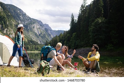 Smiling Young People Enjoying Nature Beside Tents And Talking Outdoor