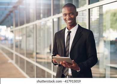 Smiling Young Professional African Man With A Digital Tablet 