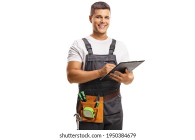 Smiling Young Repairman With A Tool Belt Writing On A Clipboard Isolated On White Background