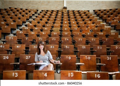 Smiling Young Student In Empty Lecture Hall