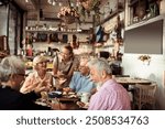 Smiling young waitress taking order from diverse senior people at a bistro