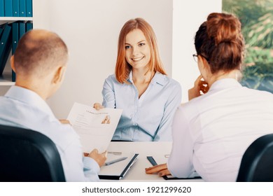 Smiling young woman during interview in small start-up