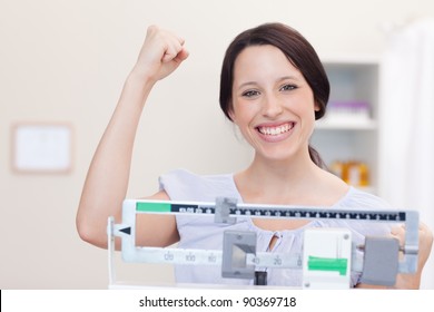 Smiling Young Woman Happy About What The Scale Shows