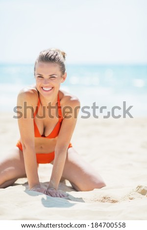 Smiling young woman having having fun time on beach