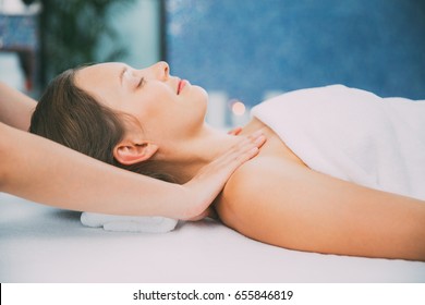 Smiling Young Woman Having Neck Massage In Spa