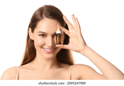 Smiling Young Woman Holding Bottle With Natural Essential Oil On White Background, Closeup