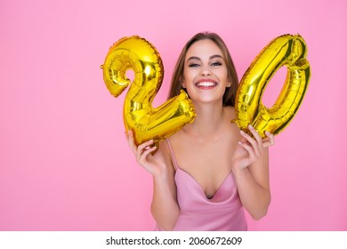Smiling young woman is holding foil balloons in the form of numbers 20 twenty percent. The concept of discounts, sales and cashback. Pink studio background.  - Shutterstock ID 2060672609