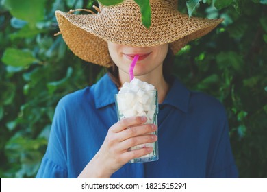 Smiling Young Woman Holding Glass Full Of Sugar Cubes With A Straw, Hidden Sugar In Drinks Concept, Risk Of Diabetes