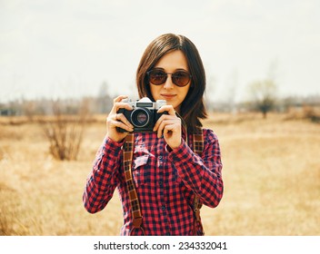 Smiling Young Woman Holding Vintage Old Photo Camera In Autumn Outdoor