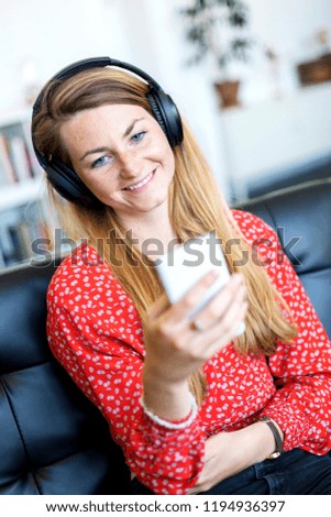 Similar – Happy woman listening to music wearing headphones