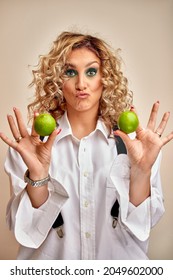 Smiling Young Woman Juggling With Two Green Apples