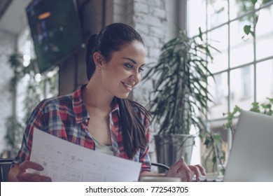 Lächelnde junge Frau mit Laptop