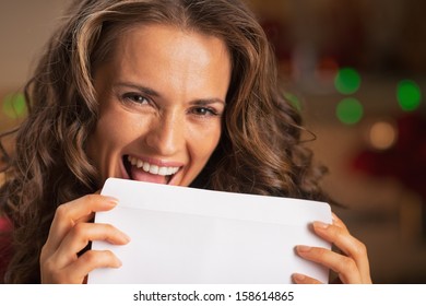 Smiling Young Woman Licking Envelope