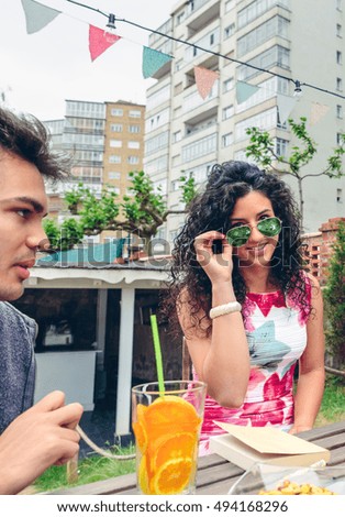 Smiling young woman looking at camera over sunglasses