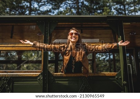 Similar – Happy young woman looking back through the window car