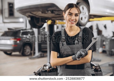 Similar – Image, Stock Photo Mechanic woman standing on motorcycle factory