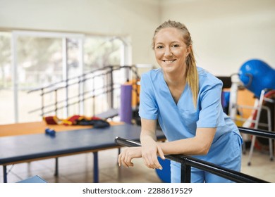 Smiling young woman as physiotherapist standing in gym of nursing home - Powered by Shutterstock