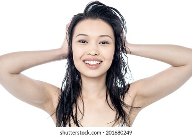 Smiling young woman playing with long hair