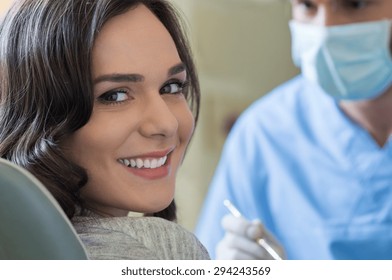 Smiling young woman receiving dental checkup