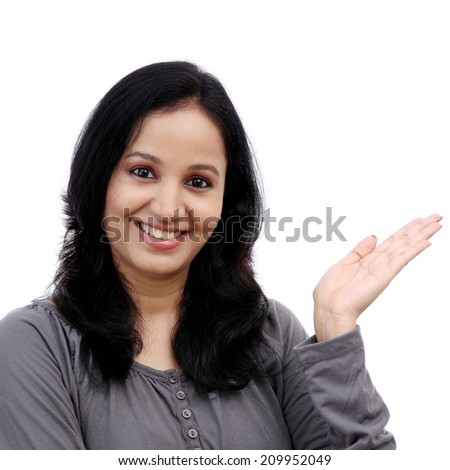 Smiling young woman showing isolated presentation against white