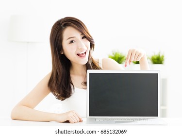 Smiling Young Woman Showing Laptop Screen 