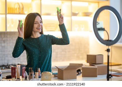 Smiling young woman showing tips on hairstying with curlers