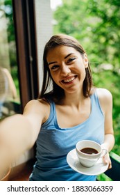 Smiling Young Woman Taking Selfie With Smartphone Camera.Making Video Call From Home Isolation During COVID -19 Coronavirus Pandemic.Online Chat Date.Virtual Communication.Social Distancing Concept