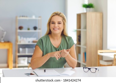 Smiling Young Woman, Tutor, Life Coach Or Psychologist, Sitting At Desk Looking At Camera, Talking To Students Or Clients During Online Video Call, Sharing Useful Tips, Giving Positive Thinking Advice