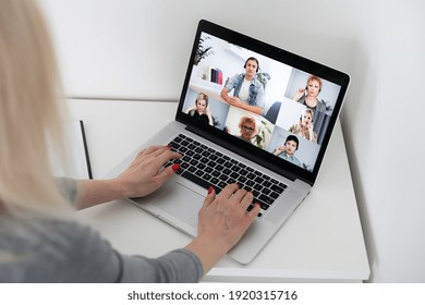 Smiling young woman using laptop, sitting at home, beautiful girl chatting online in social network, having fun, watching movie, freelancer working on computer project. - Shutterstock ID 1920315716