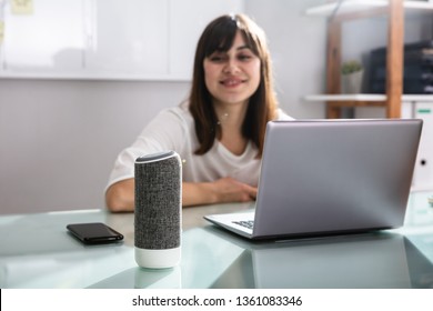 Smiling Young Woman Using Voice Assistant In Office - Powered by Shutterstock