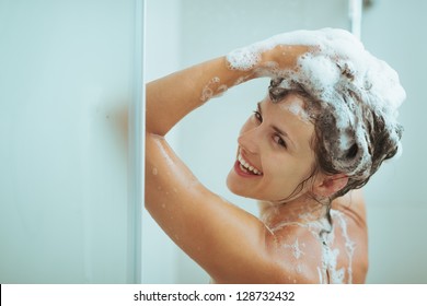 Smiling Young Woman Washing Head With Shampoo